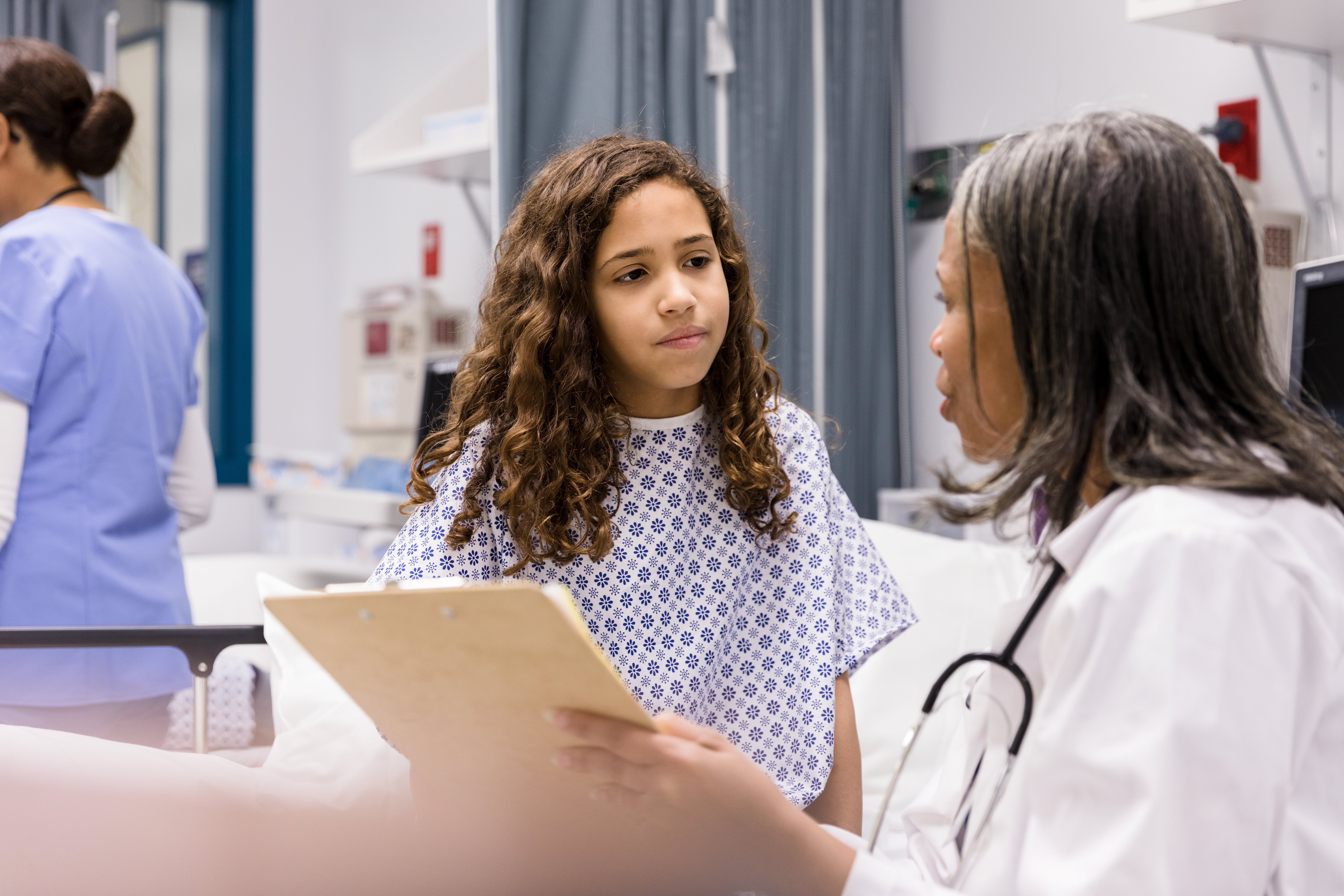 Little girl talking to her doctor