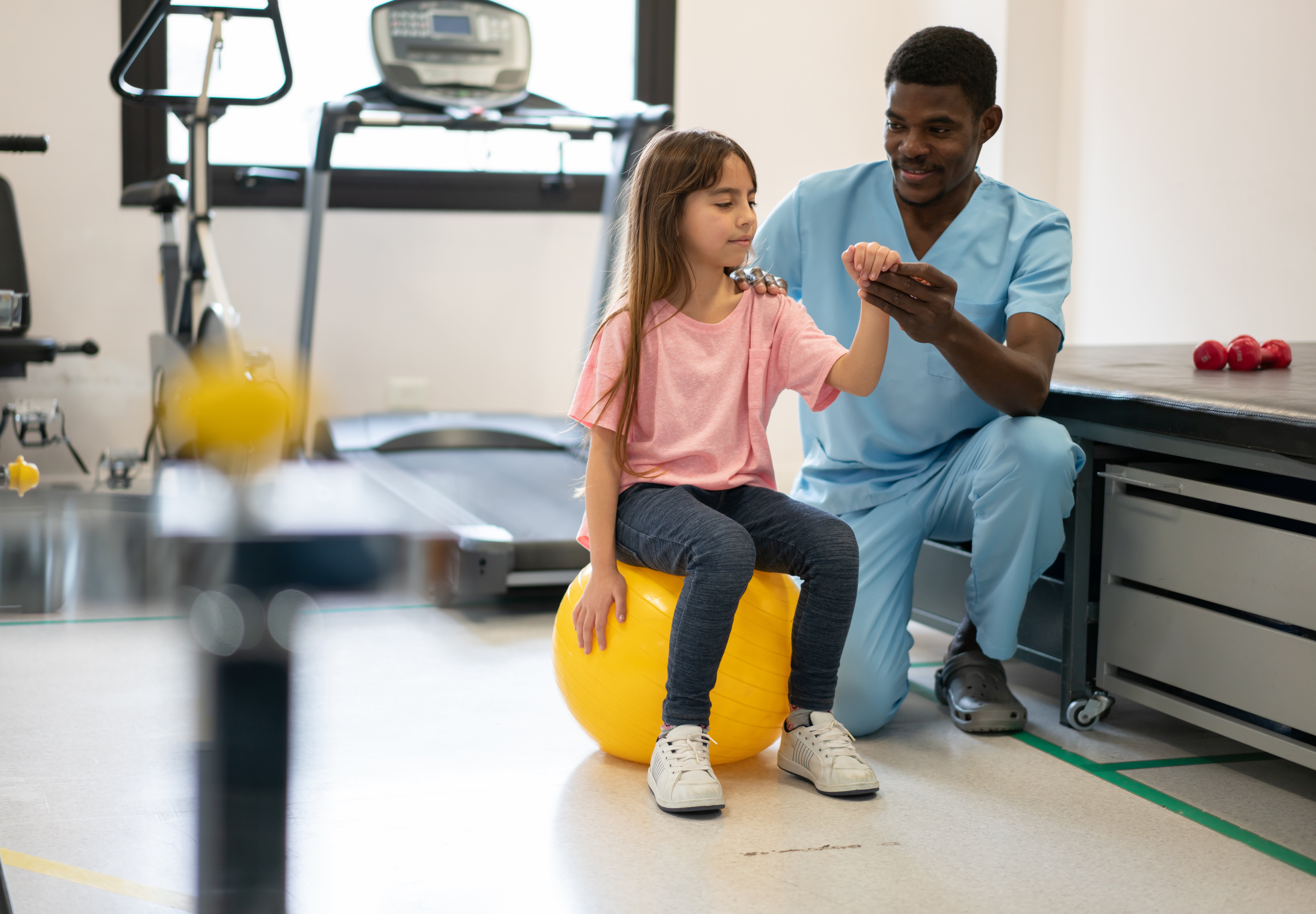 Young girl with physical therapist
